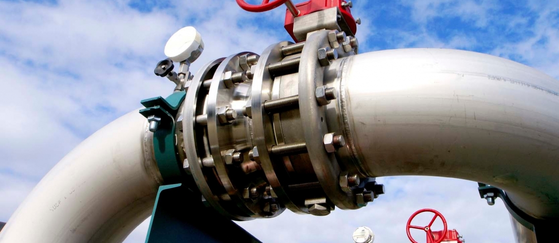 Industrial zone, Steel pipelines and valves against blue sky